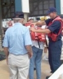 photograph of men putting on life jackets for patrol boats