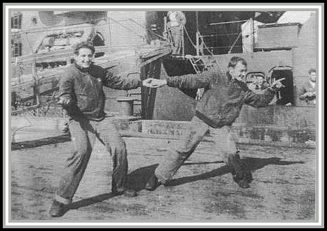 photograph of Cometa and Garnet doing a celebratory dance on the dock.