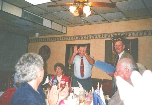 photograph of Ray receiving his "Admiral's" Certificate from Gene Hansen