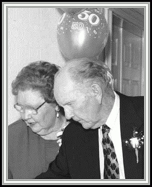 photograph of G. O. and Patricia cutting their cake at their 50th wedding anniversary