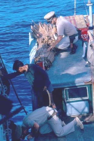 photograph showing crewmembers searching a Vietnamese junk