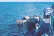 photograph of crew searching junk