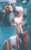 photograph of crewmembers airing their linens on deck