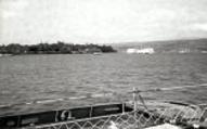 photograph of the USS Savage passing the USS Arizona Memorial