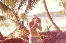 photograph of Roy Giroir drinking coconut milk