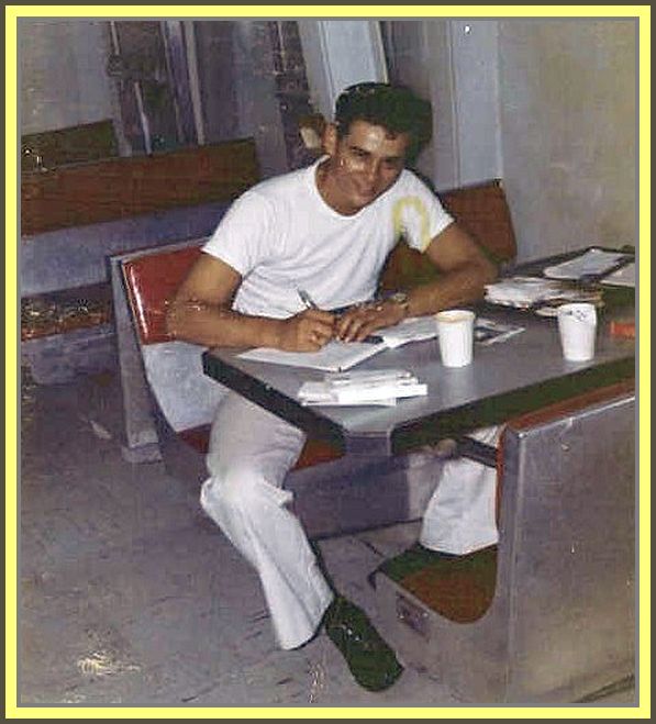 photograph of Ed Rego Writing letter home in the mess deck